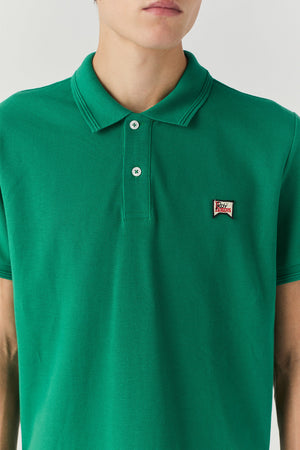 Polo in piquet con logo verde